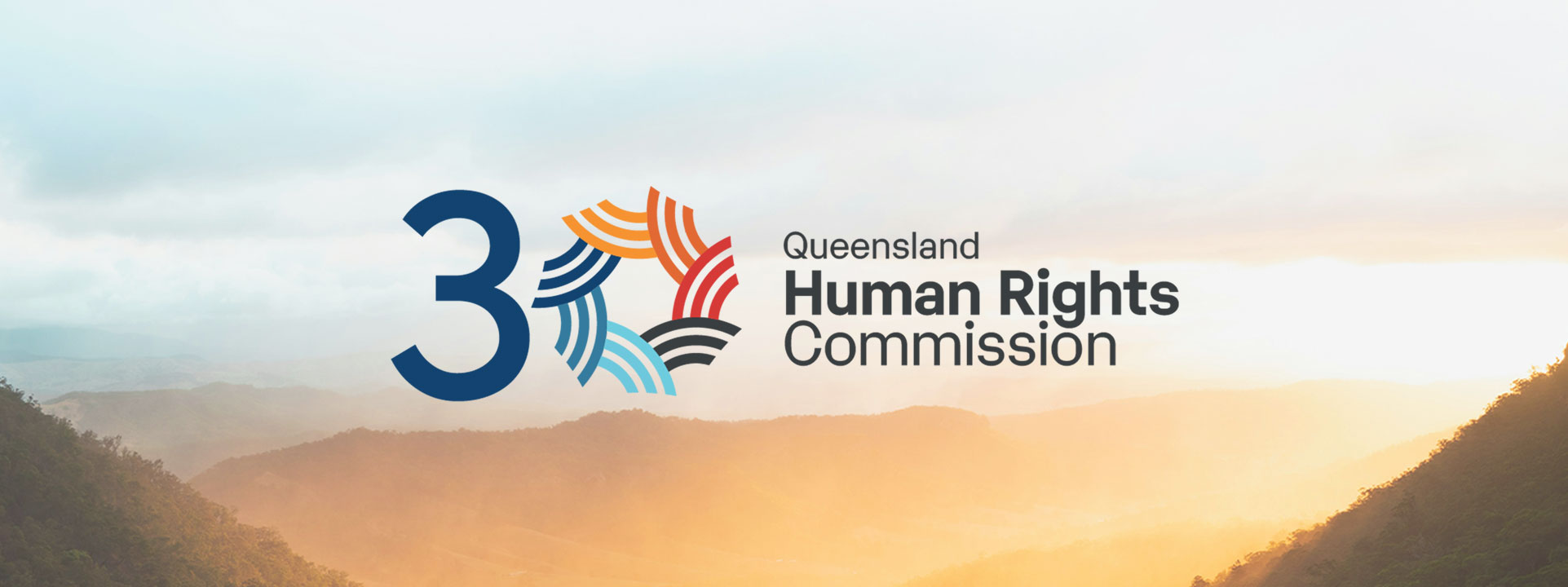 QHRC 30th anniversary logo amongst a landscape of Lamington National Park mountains